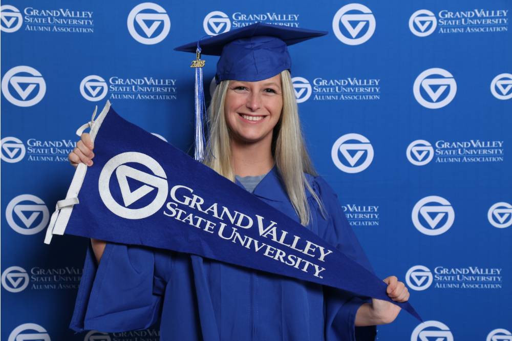 Future alumna holds GV flag at Gradfest